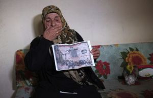 survivor with photo of murdered family