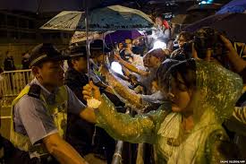 protesters shelter police from rain